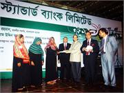 BB Governor hands cheque at the 13th Anniversary of Standard Bank Ltd. held in the city recently