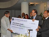 BB Governor Dr. Atiur Rahman hands over a cheque worth taka 5 lakh to Professor Abdullah Abu Sayeed for Biswa Shahitto kendro organized by First Security Islamic Bank recently