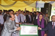 Honorable Governor Dr. Atiur Rahman disbursing SME loan to a small woman entrepreneur in "Bank-NASCIB SME Saikat Utshab-2011" at Cox´s Bazar on 11th November 2011